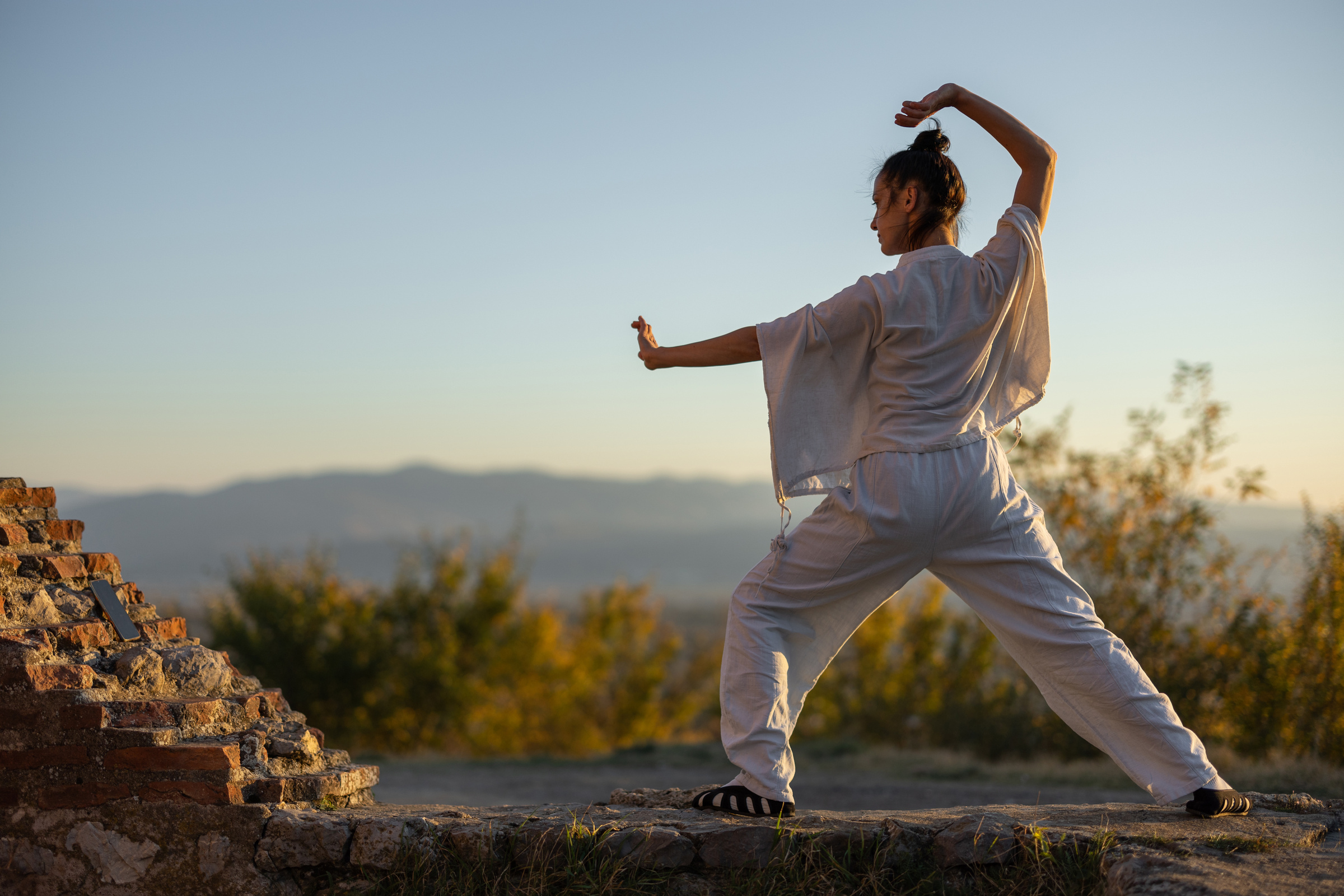 Woman doing tai chi outdoors